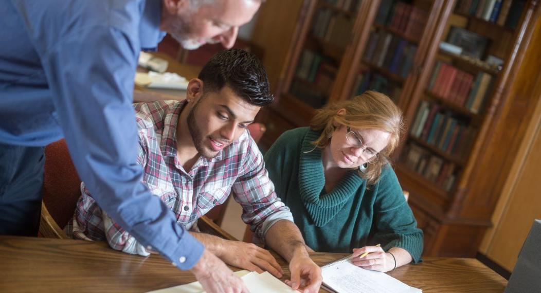 Students view archives with Special Collections staff